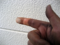 外壁を指で擦る